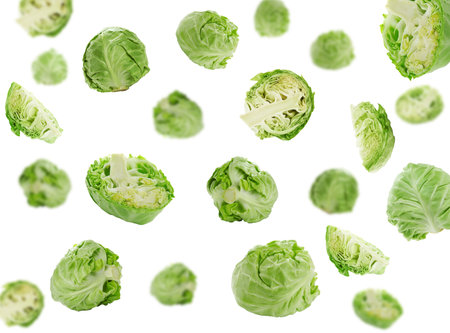 Fresh ripe cabbages falling on white backgroundの写真素材
