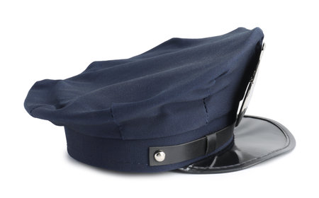 One dark blue police cap on white backgroundの写真素材