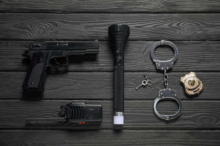 Different police equipment on black wooden table, flat layの写真素材
