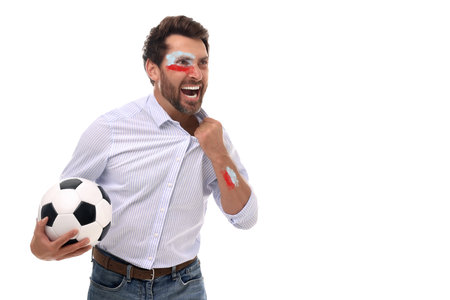 Excited fan with flags of Poland painted on his body holding soccer ball against white background. Space for textの写真素材