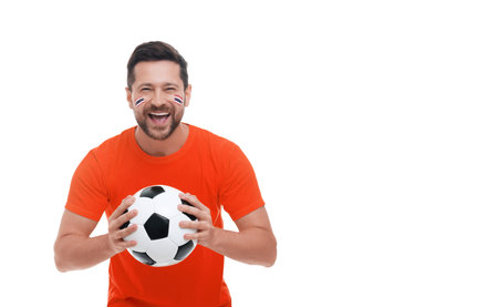 Excited fan with flags of Thailand painted on his face holding soccer ball against white background. Banner design with space for textの写真素材
