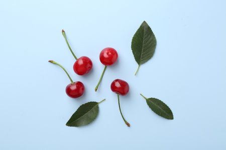 Fresh ripe cherries on light background, flat layの写真素材