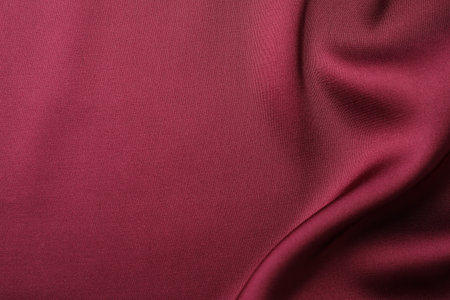 Crumpled burgundy silk fabric as background, top viewの写真素材