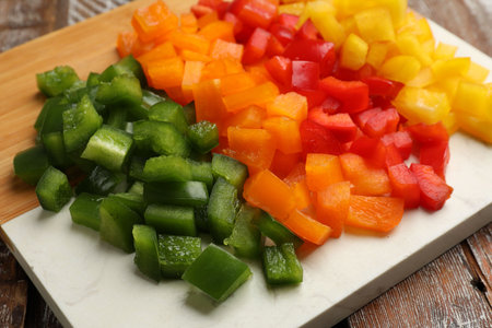 Cut colorful bell peppers on wooden table, closeupの写真素材