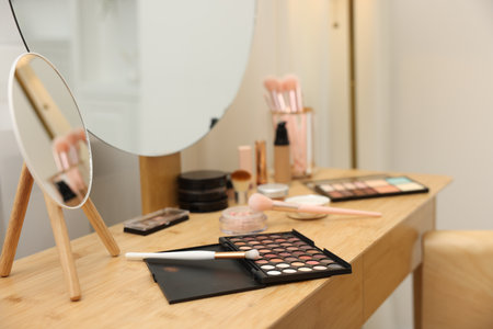 Different makeup products and brushes on vanity indoors, closeupの写真素材