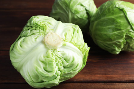 Fresh whole cabbages on wooden table, closeupの写真素材