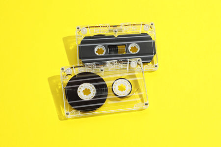 Audio cassettes with magnetic tapes on yellow backgroundの写真素材