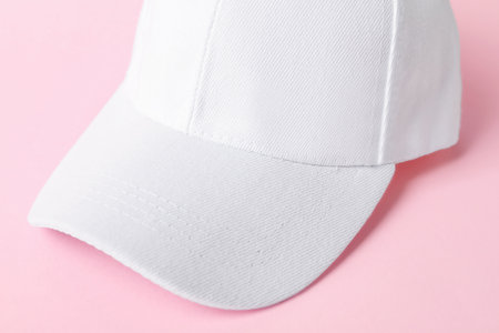 White baseball hat on pink background, closeup. Mockup for designの写真素材