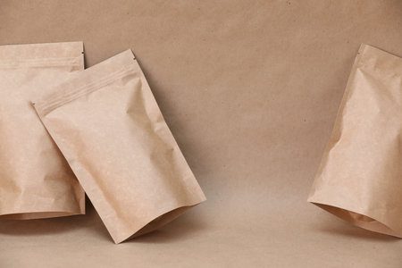 Zipper stand-up pouches on kraft paper background. Mockup for designの写真素材