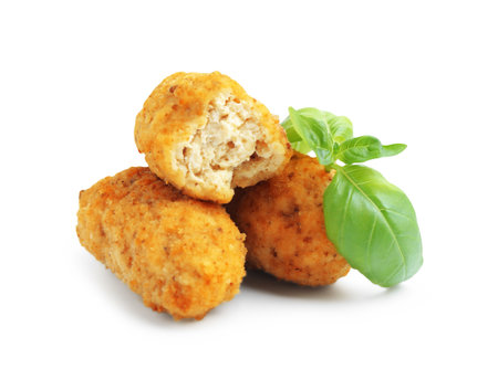 Tasty fried croquettes and basil isolated on whiteの写真素材