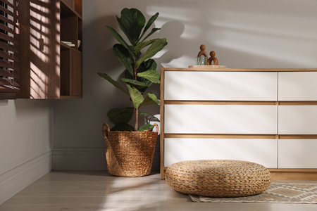 Stylish wicker pouf and home decor indoorsの写真素材