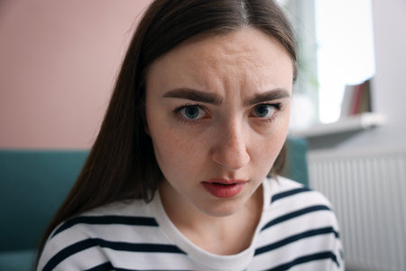 Scared woman suffering from paranoia at homeの写真素材