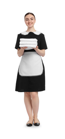 Chambermaid with stack of clean towels on white backgroundの写真素材