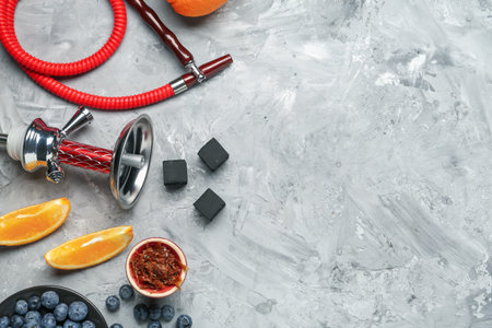 Hookah, coal and fresh fruits on gray table, flat lay. Space for text