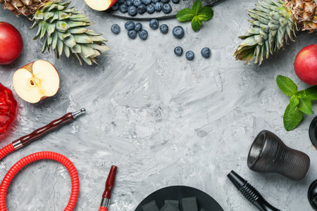 Frame of hookah and fresh fruits on gray table, flat lay. Space for textの写真素材
