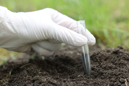 Scientist soil taking sample for research outdoors, closeup