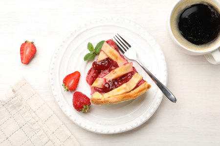 Piece of tasty strawberry pie and berries on white wooden table, top viewの写真素材