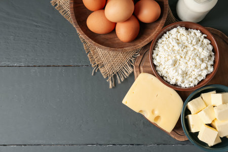 Different dairy products and eggs on gray wooden table, flat lay. Space for textの写真素材