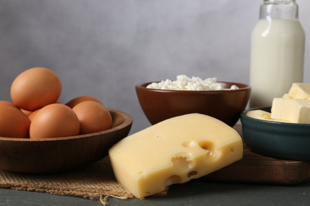 Different dairy products and eggs on gray wooden table, closeupの写真素材