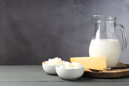 Different dairy products on gray wooden table, space for textの写真素材