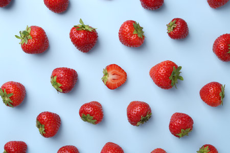 Fresh ripe strawberries on light background, flat layの写真素材