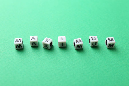 Word Maximum made of cubes on green backgroundの写真素材