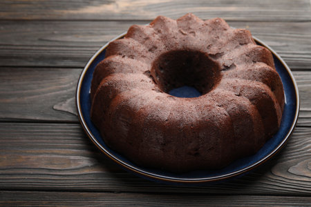 Tasty chocolate bundt cake on wooden table, closeupの写真素材