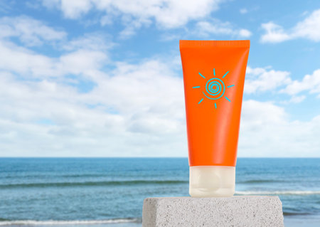 Sunscreen product in tube with drawing of sun on beach. Stylish presentation