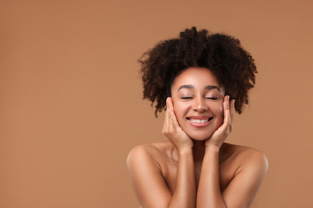 Portrait of beautiful Brazilian woman after spa treatment on light brown background. Space for textの写真素材