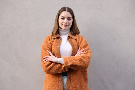 Portrait of beautiful teenage girl near gray wallの写真素材