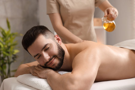 Man receiving relaxing massage in spa salonの写真素材