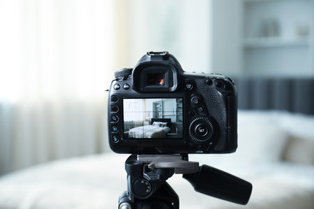 Shooting large bed with professional photo camera in studio, selective focusの写真素材