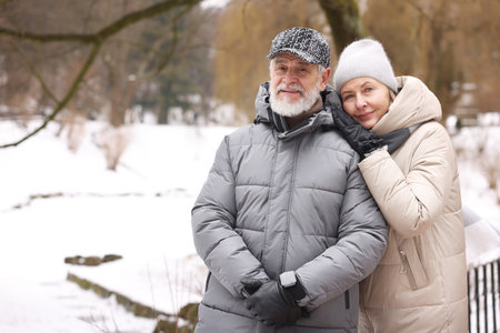 Portrait of happy senior couple at winter park. Space for textの写真素材