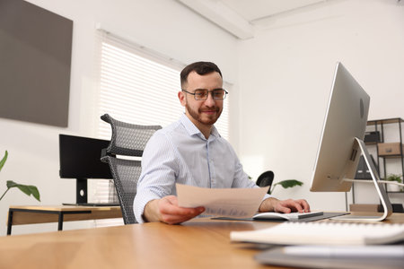 Handsome man working at desk in office