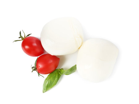 Tasty mozzarella cheese balls, tomatoes and basil on white background, top viewの写真素材