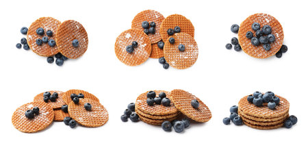 Yummy Dutch waffles (stroopwafels) with fresh blueberries on white background, collageの写真素材