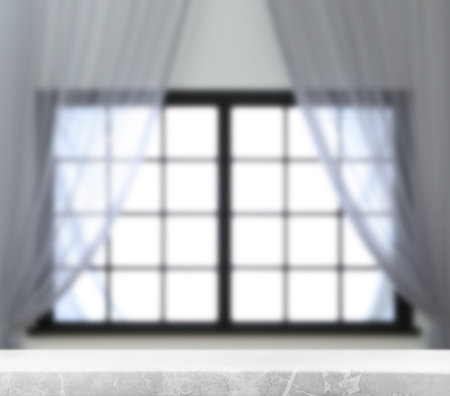 Empty marble table against window with curtains in roomの写真素材