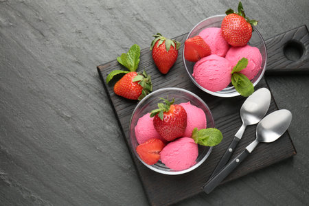 Refreshing sorbet, strawberries and mint on gray textured table, top view. Space for textの写真素材