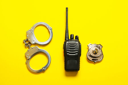 Different police equipment on yellow background, flat layの写真素材