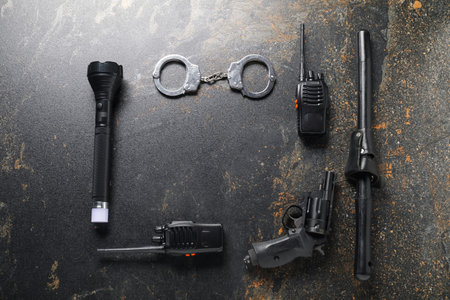 Different police equipment on dark table, flat lay. Space for textの写真素材