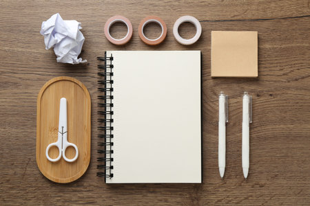 Flat lay composition with notebook on wooden table