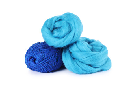 Felting wool and knitting yarn isolated on whiteの写真素材