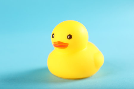 One cute rubber duck on light blue background, closeupの写真素材