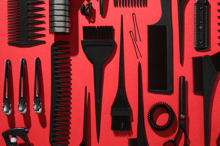 Different hairdresser's tools on red background, flat layの写真素材