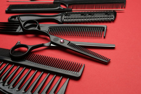 Different hairdresser's tools on red background, closeupの写真素材