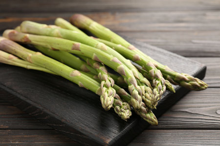 Fresh raw asparagus on black wooden table, closeupの写真素材