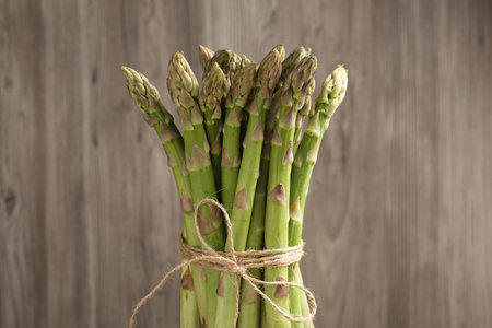 Fresh raw asparagus spears on wooden background, closeupの写真素材