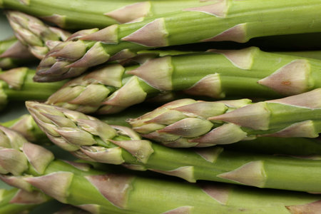 Many fresh raw asparagus spears as background, top viewの写真素材