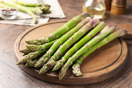 Fresh raw asparagus on wooden table, closeupの写真素材