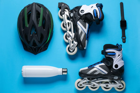 Flat lay composition with roller skates on blue background